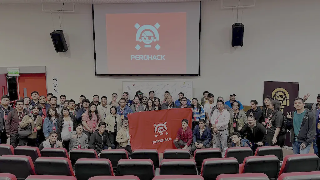 Foto grupal de PERÚHACK 2023 con la bandera del evento
